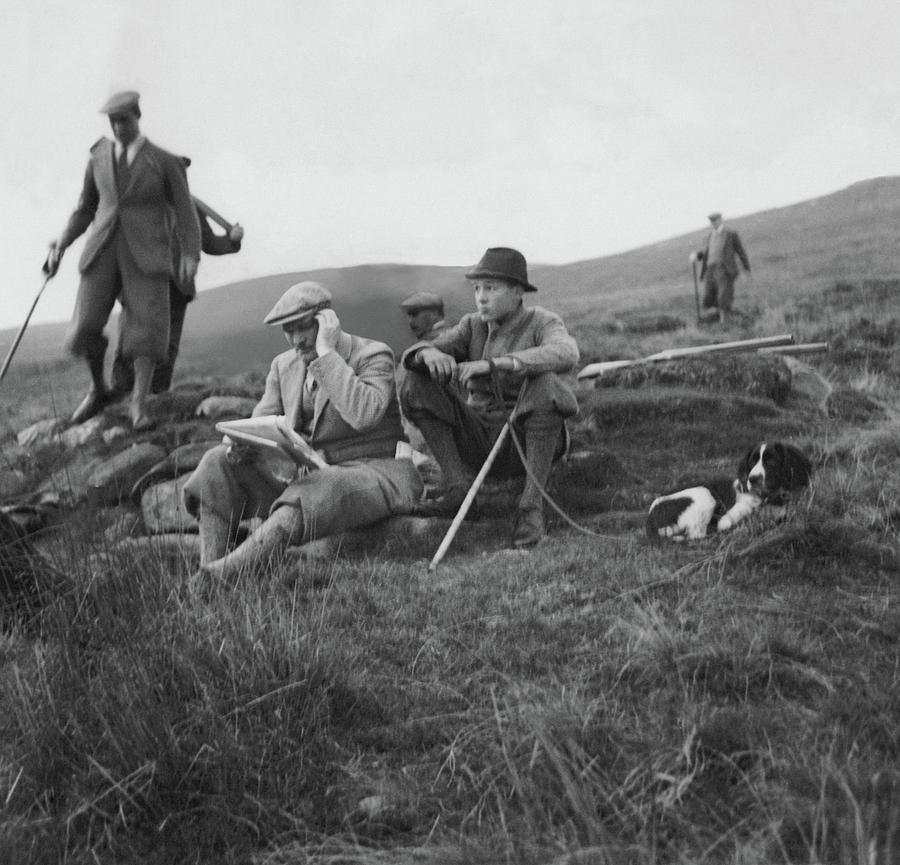 Gurnee Munn And Gurnee Munn Jr. Sitting On Grassy Photograph by John Mcmullin
