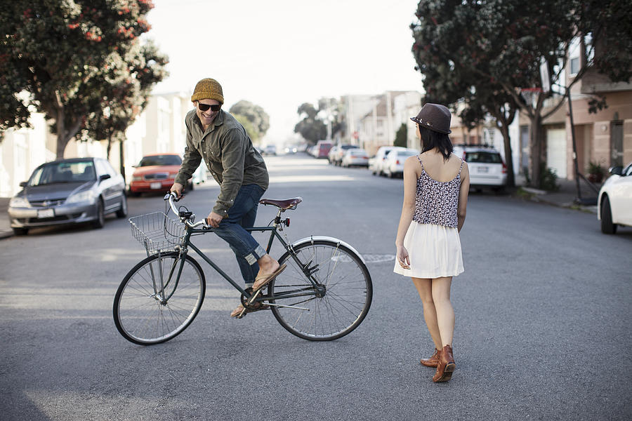 Guy riding circles around girl on bicycle Photograph by Justin Lewis