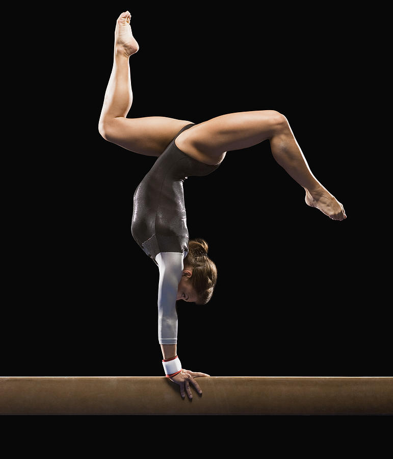 Gymnast on balance beam Photograph by Mike Kemp