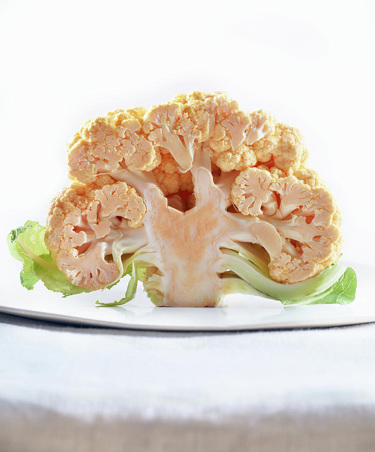 Half Of A Cauliflower On A Plate Photograph by Maren Caruso