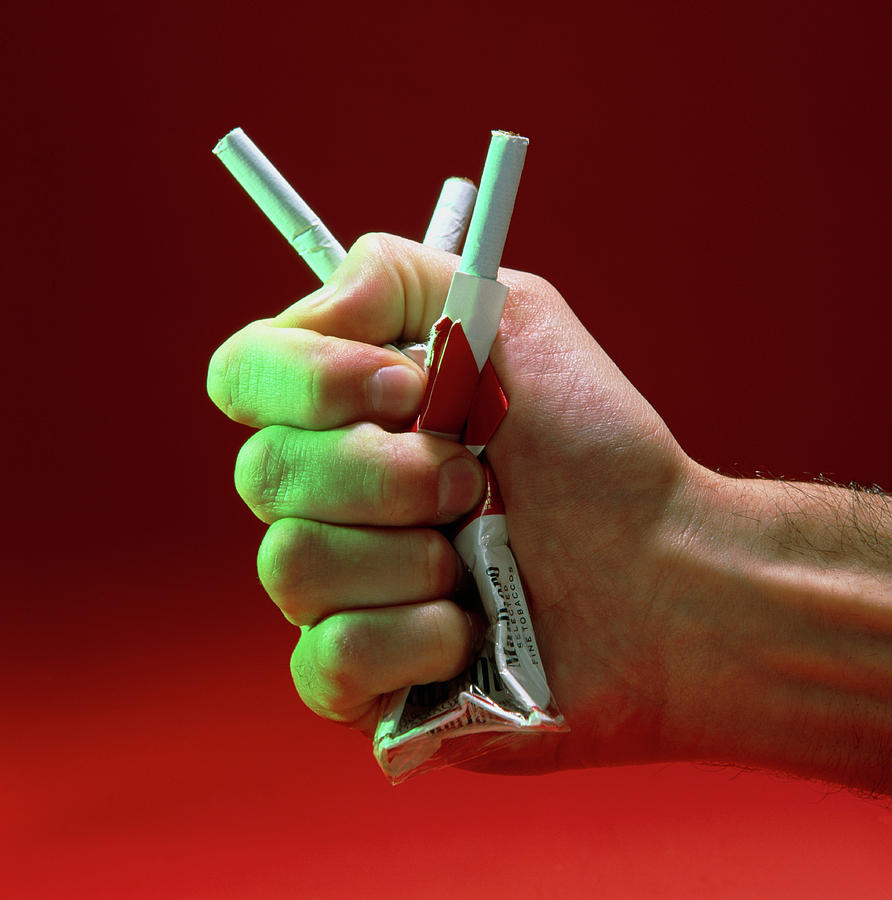 Hand Crushing A Packet Of Cigarettes Photograph by Sheila Terry/science Photo Library