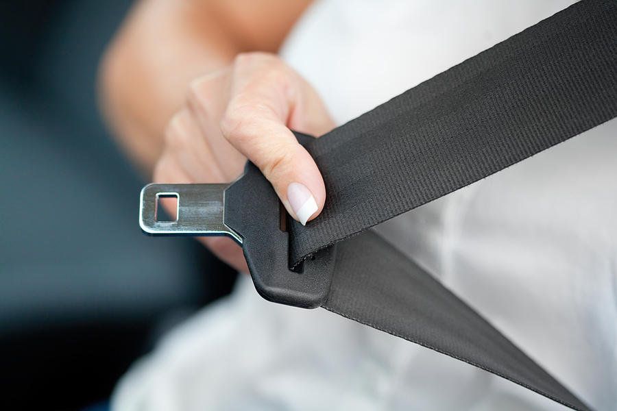 Hand pulling seat belt Photograph by Deepblue4you
