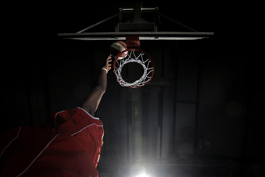 Hand reaching high for the basket Photograph by Compassionate Eye Foundation/Steve Coleman/OJO Images Ltd