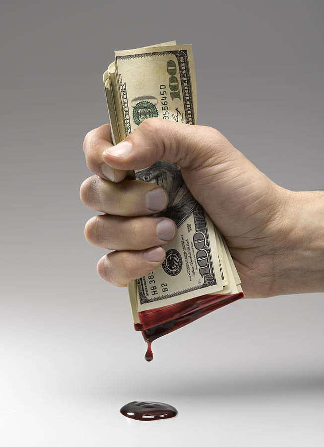 Hand Squeezing Blood From Money Photograph by Jeffrey Coolidge