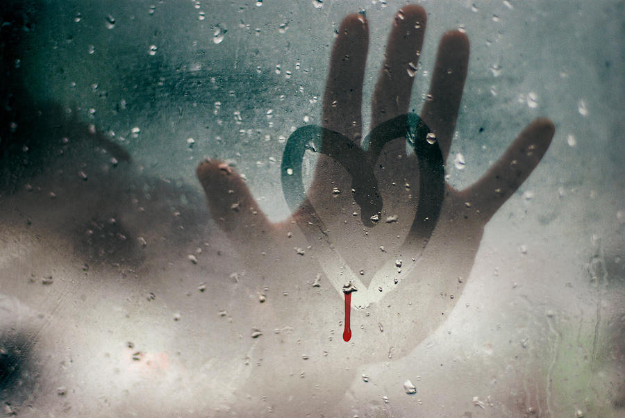 Hand touching a broken heart on a rainy window Photograph by Mihaela Muntean