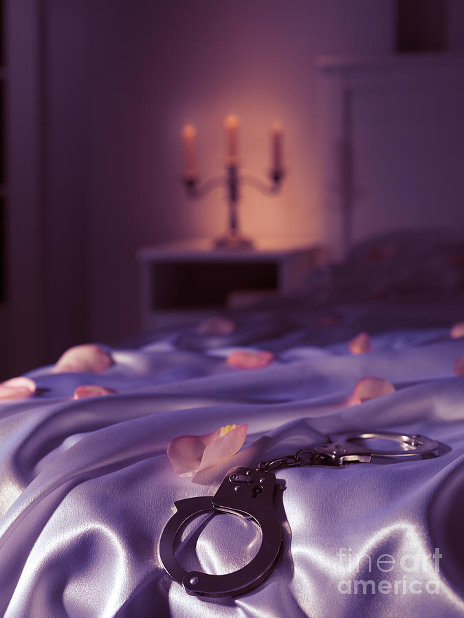 Handcuffs and rose petals on bed Photograph by Maxim Images Exquisite Prints
