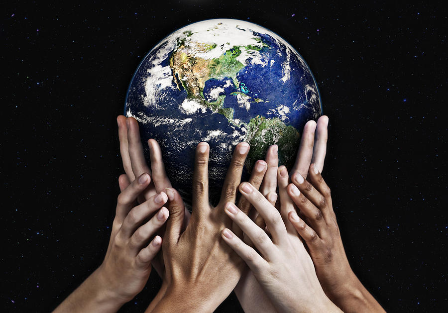 Hands cradling Mother Earth against starfield background Photograph by RapidEye