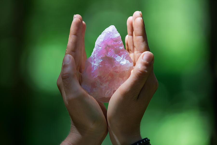 Hands holding a rose quartz Photograph by Brigitte Blättler