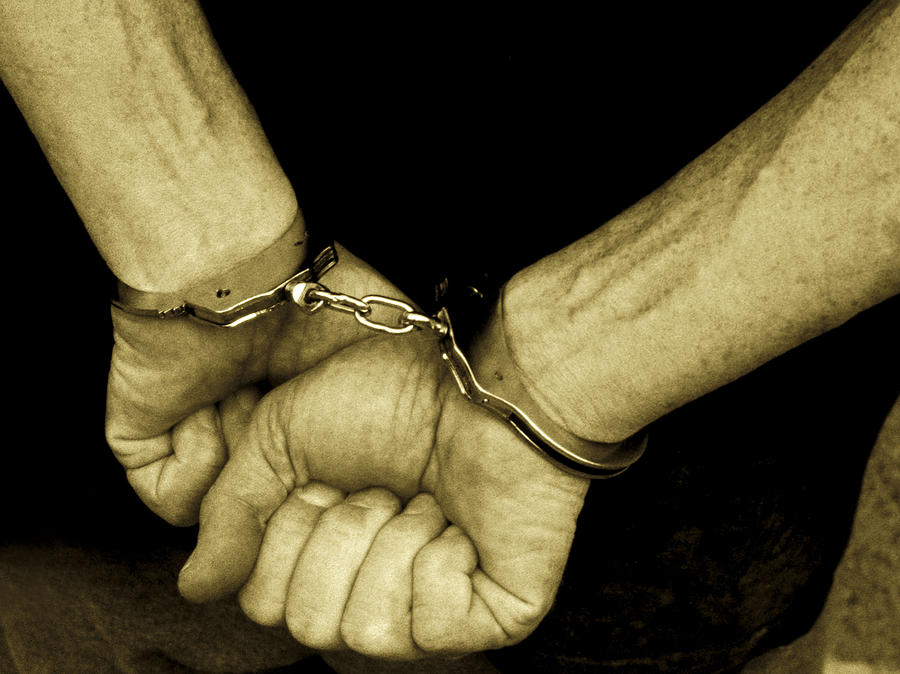 Hands in Handcuffs Photograph by Digital Vision.