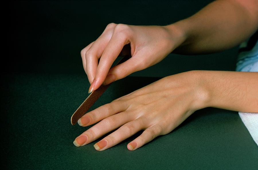 Hands Of A Model  Using An Emery Board Photograph by William Connors