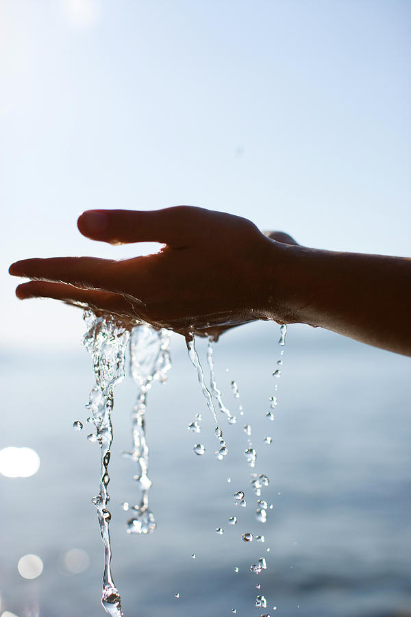 Hands With Water Flowing Photograph by Woods Wheatcroft - Pixels