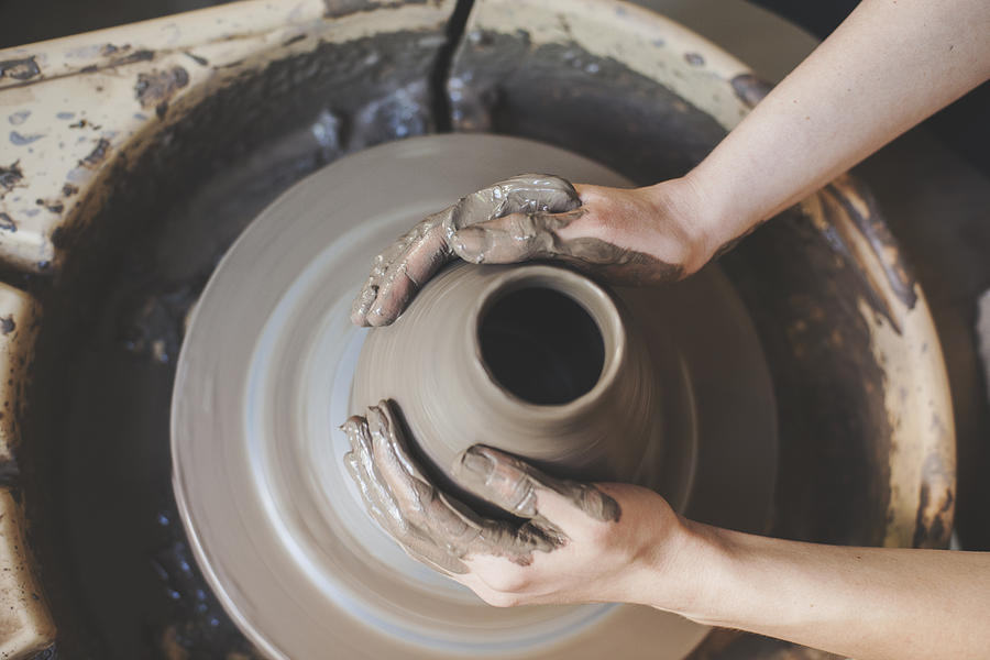 Hands working on pottery wheel Photograph by Vesnaandjic