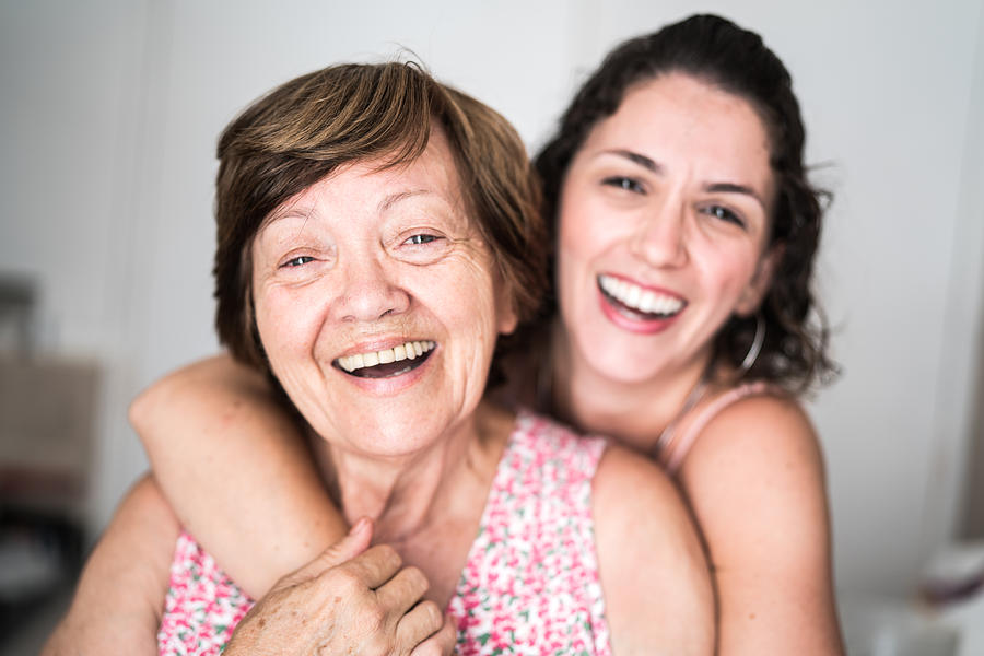 Happy adult mother and daughter embracing Photograph by FG Trade