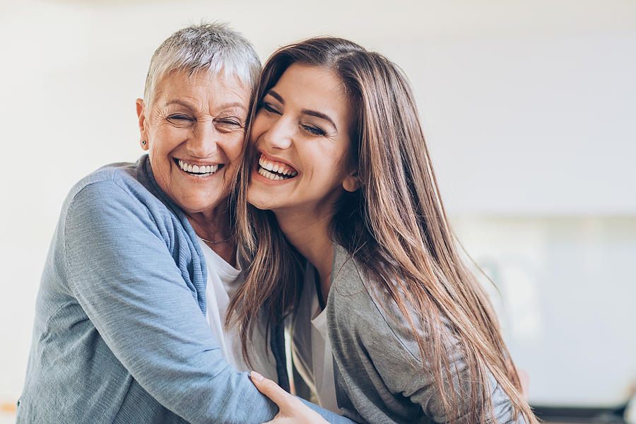 Happy adult mother and daughter embracing Photograph by Pixelfit