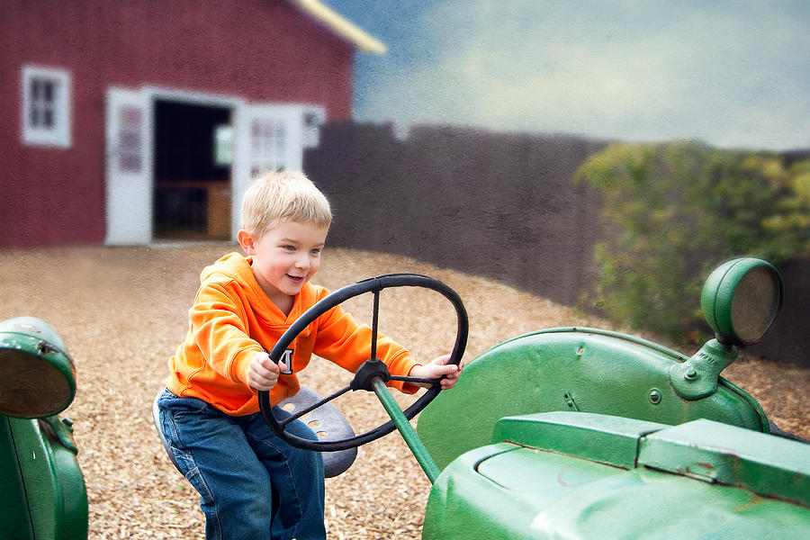 Happy boy on tractor Photograph by Rebecca Nelson