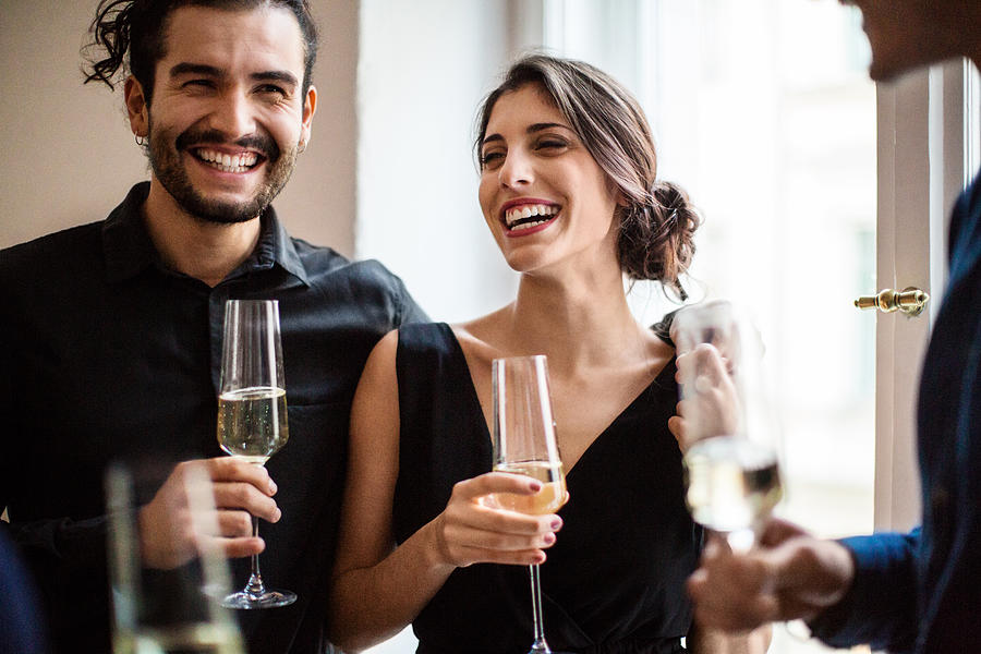 Happy couple champagne flutes during dinner party Photograph by Luis Alvarez