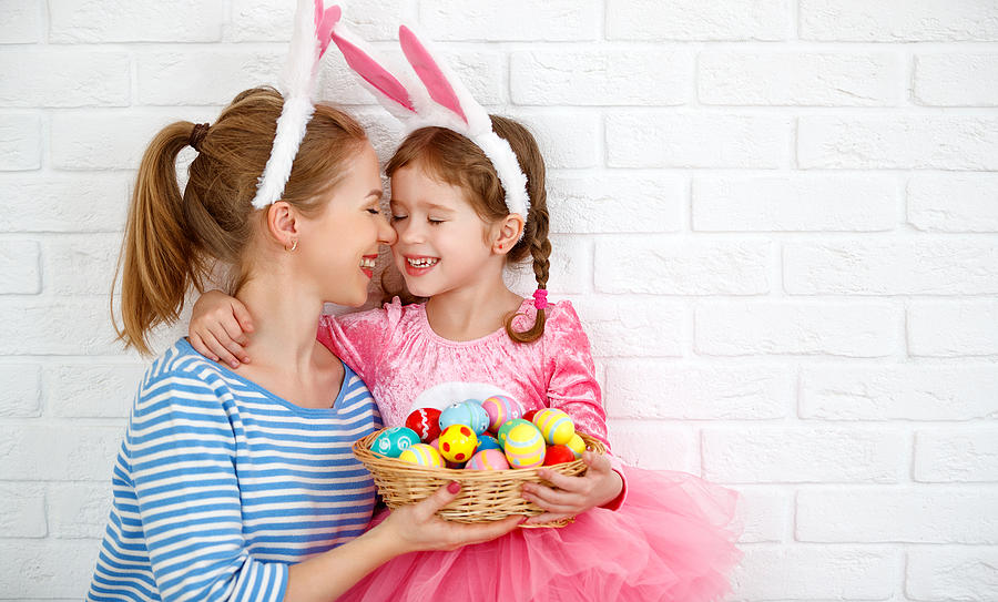 Happy easter! family mother and child daughter with ears hare getting ready for holiday Photograph by Evgenyatamanenko