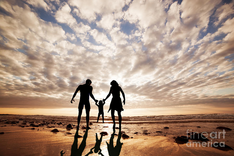 Happy family together hand in hand on the beach at sunset Photograph by Michal Bednarek