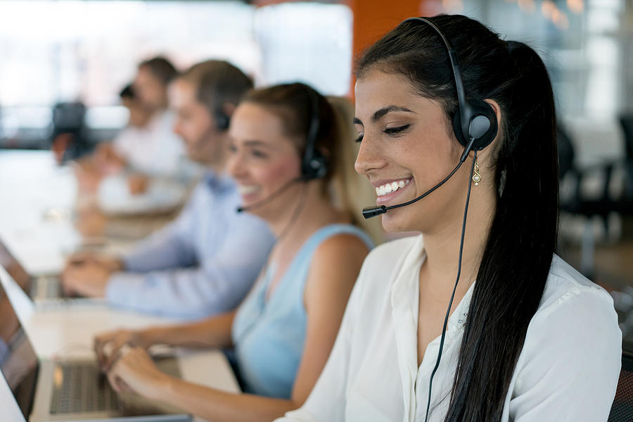 Happy group of people working at a call center Photograph by Andresr