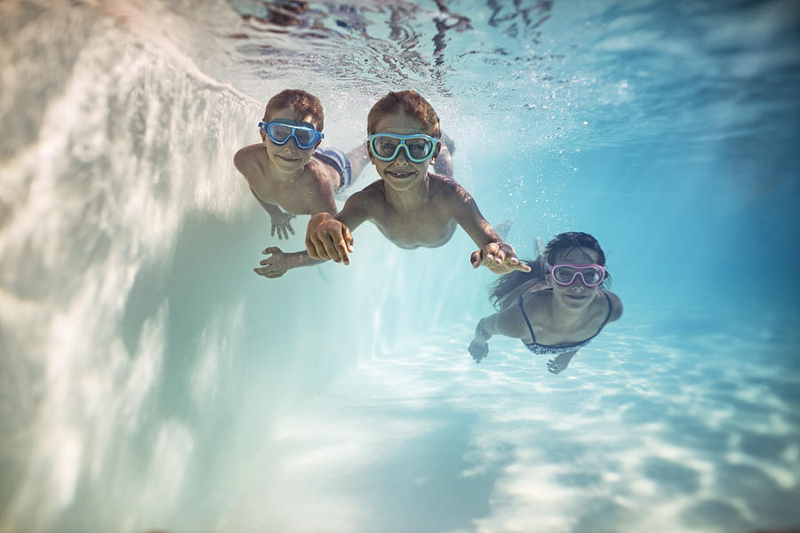 Happy kids swimming underwater Photograph by Imgorthand