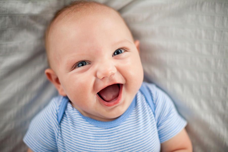 Happy, Laughing Baby Boy Lying on Textured Fabric Photograph by Ideabug
