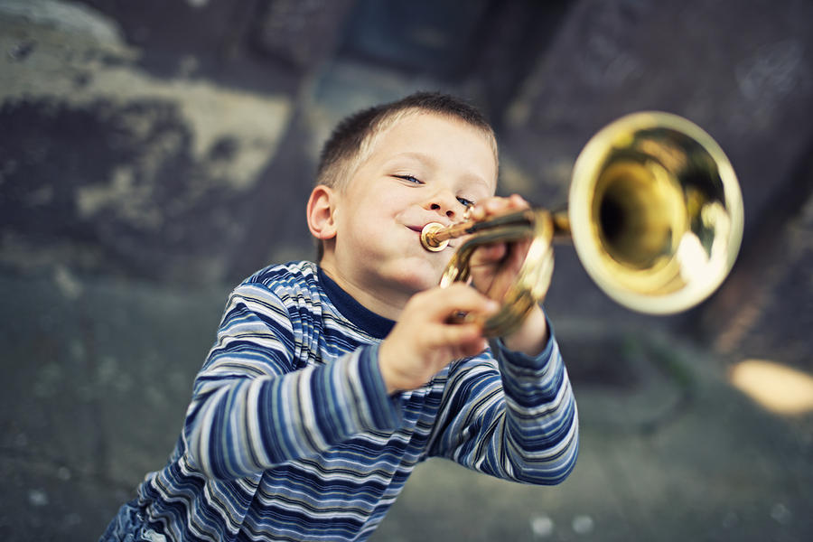 Happy little boy playing trumpet Photograph by Imgorthand