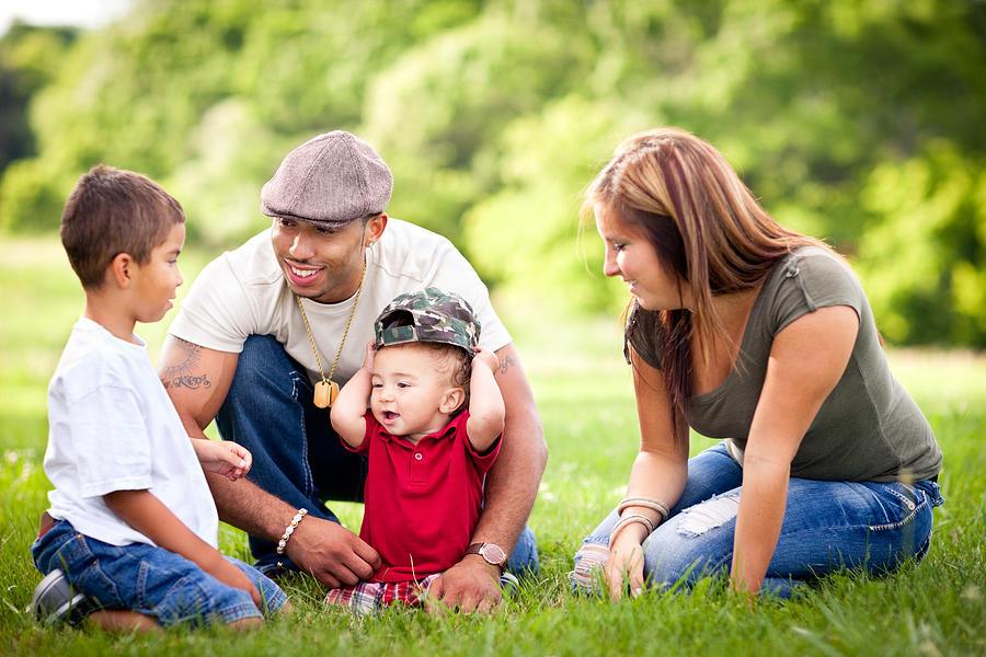 Happy, Multiracial Family Sitting Together Outside During Summer Photograph by ArtisticCaptures