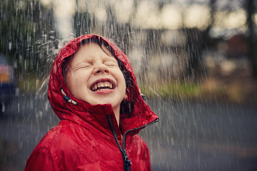 Happy smiling boy in the rain Photograph by Sally Anscombe