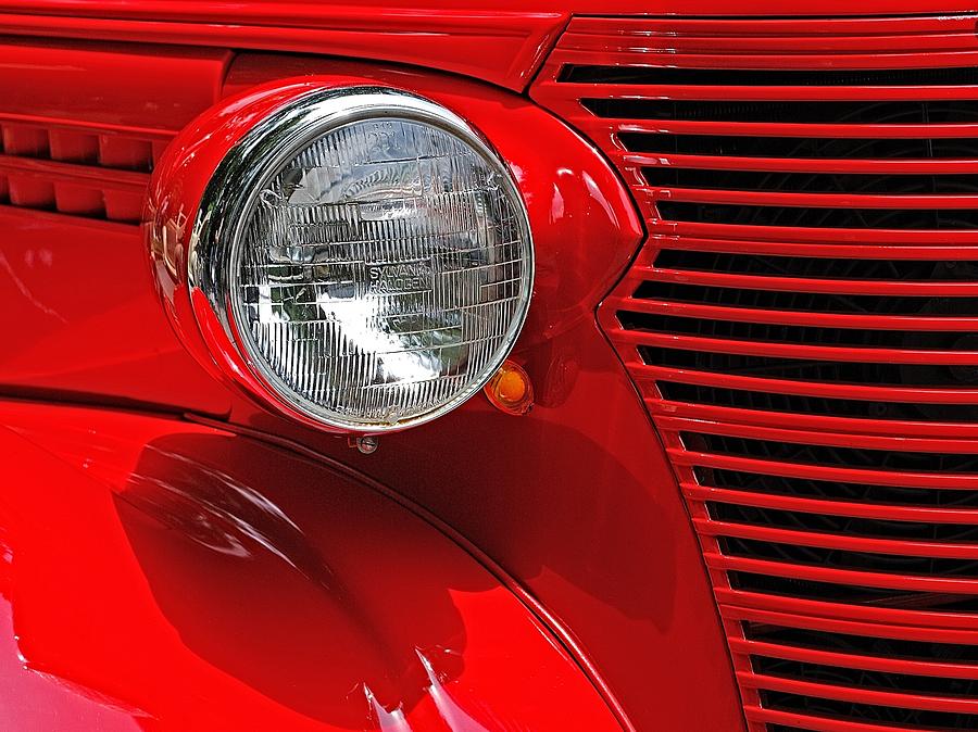 Headlight on Red Car Photograph by Ludwig Keck