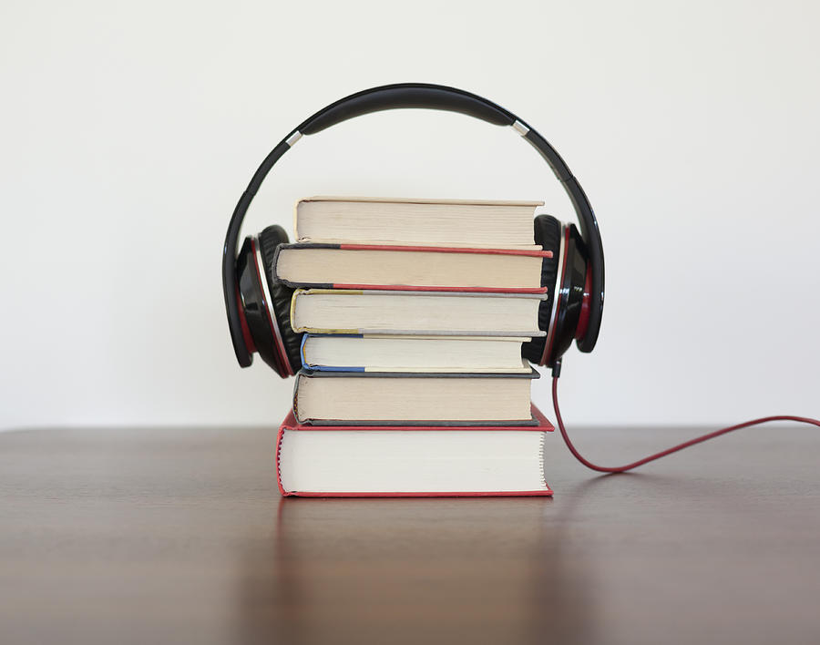 Headphones around a stack of books Photograph by Steven Errico