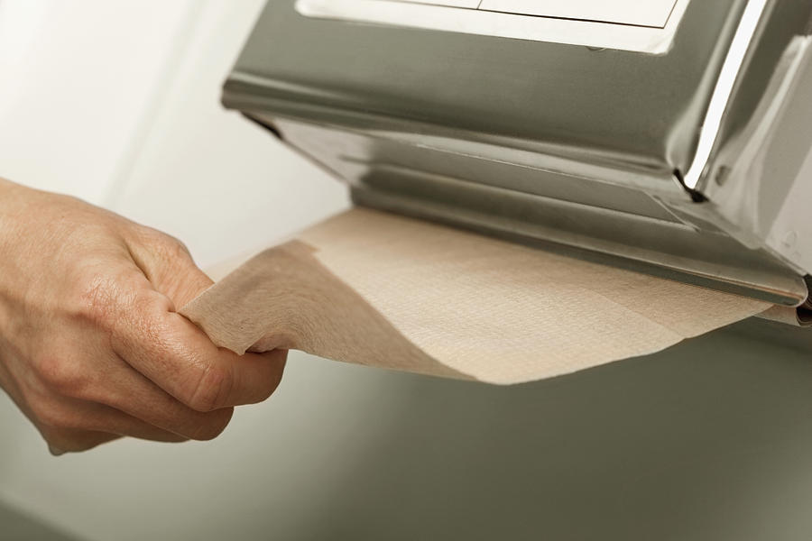 Healthcare worker pulling out paper towel in hospital Photograph by Medioimages/Photodisc