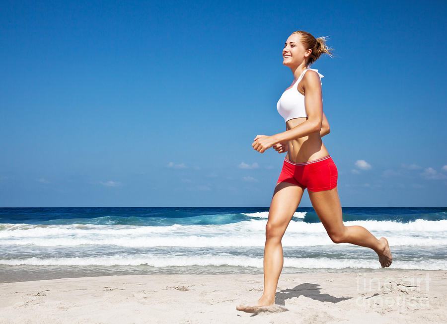 Healthy woman running on the beach Photograph by Anna Om - Fine Art America