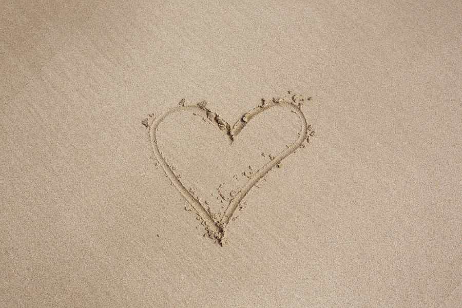 Heart shape drawing made with finger on a sand of the beach Photograph by Alexander Spatari