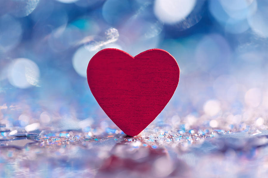 Heart shape on book with bokeh background for valentines day Photograph by Oxygen
