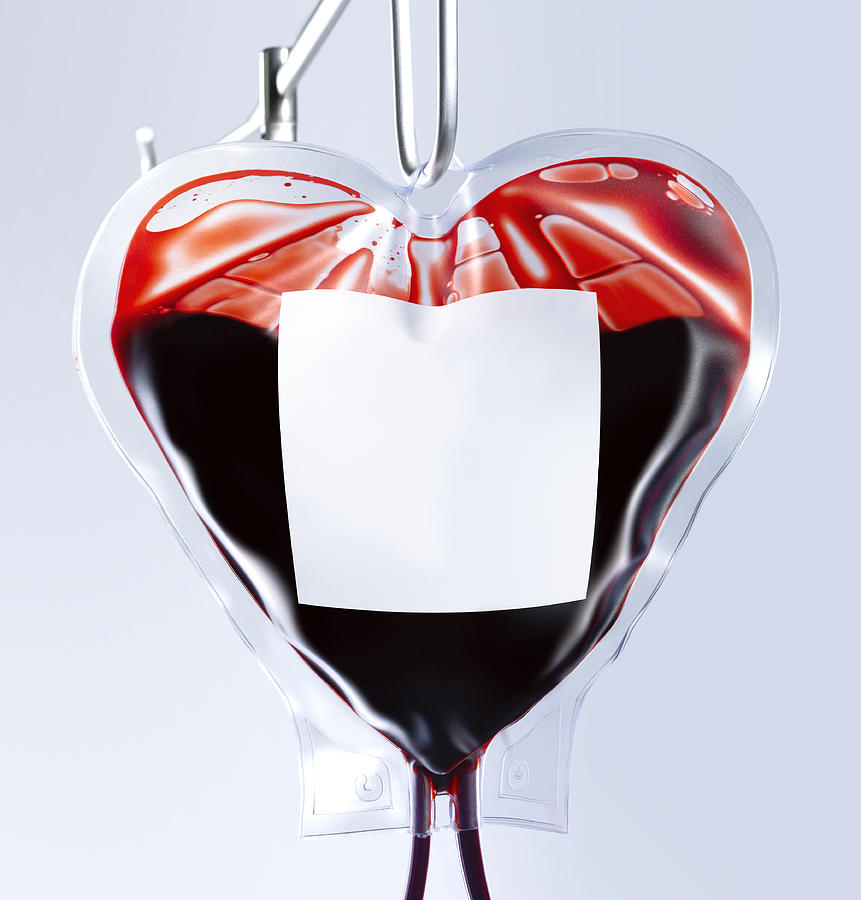 Heart shaped blood bag close up Photograph by Peter Dazeley