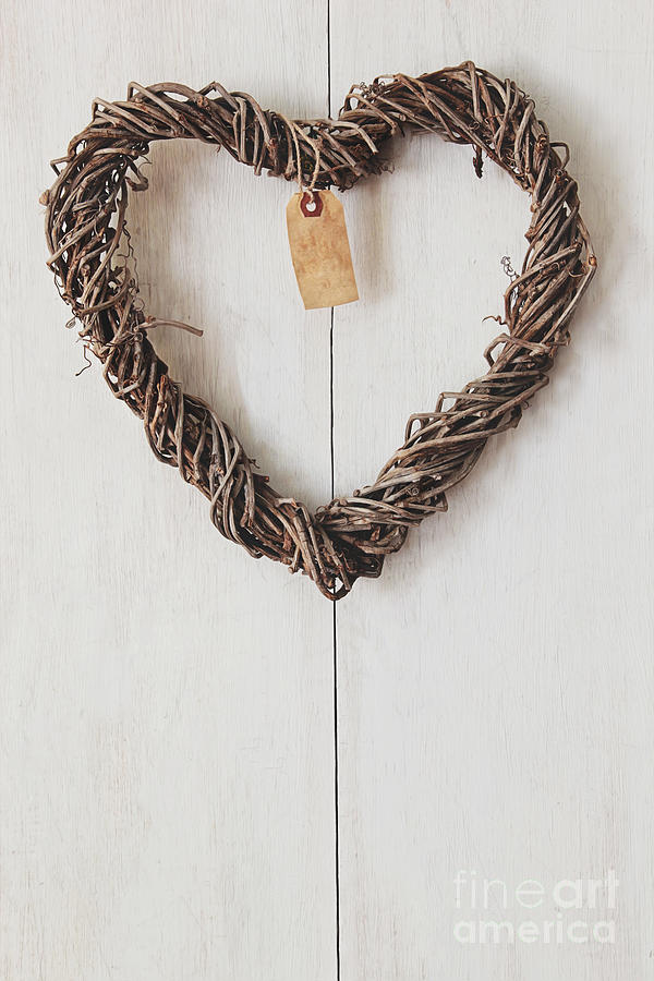 Heart wreath hanging on wood background Photograph by Sandra Cunningham