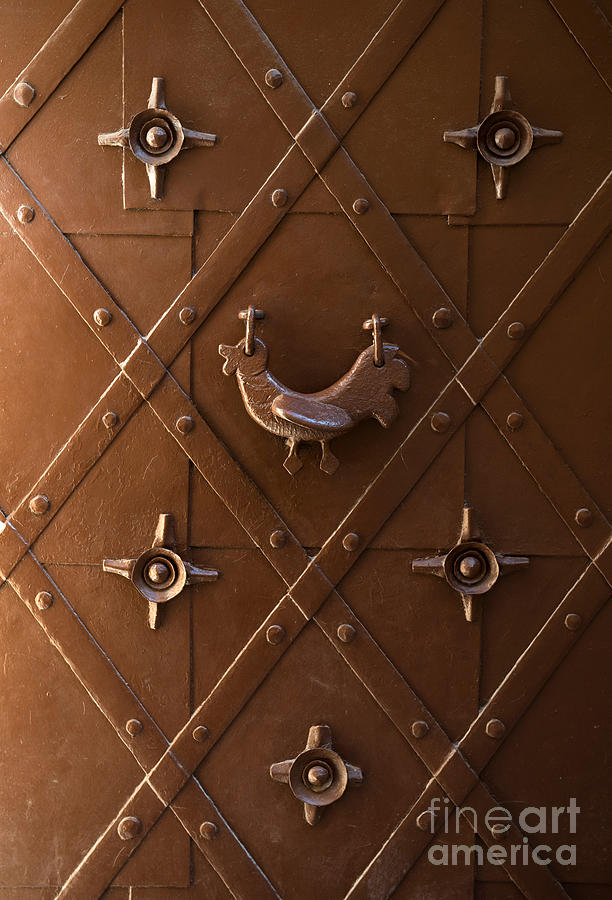 Hen shaped doorknob on a brown metal doors Photograph by Jaroslaw Blaminsky