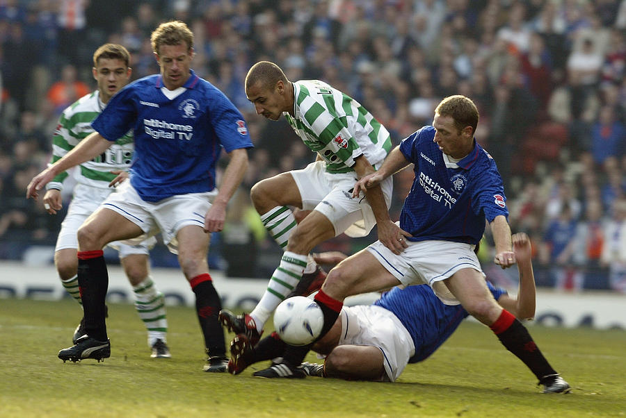 Henrik Larsson of Celtic is challenged by Craig Moore and Bert Konterman of Rangers Photograph by David Cannon