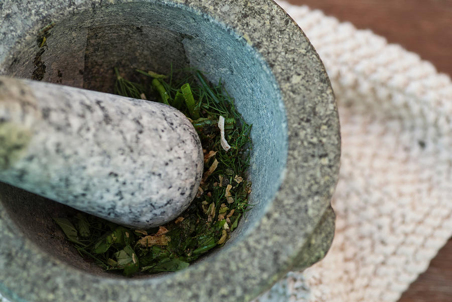 Herbs Being Ground In Pestle And Mortar Photograph by Luka