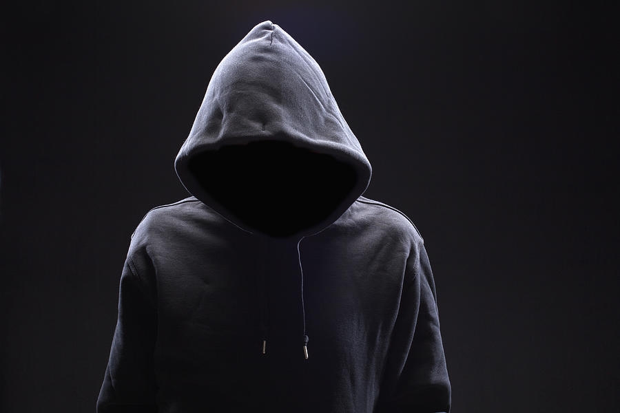 Hidden man in hooded top Photograph by Larry Washburn