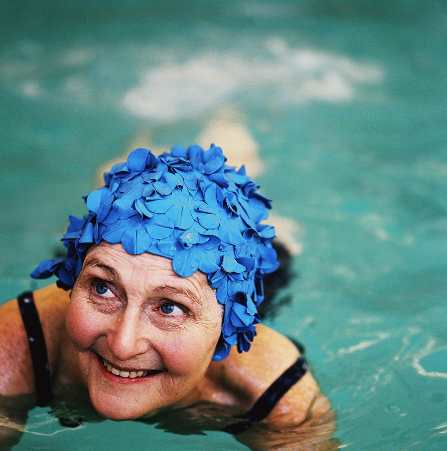 High Angle View Of An Elderly Woman In The Swimming Pool; Smiling Photograph by Stockbyte