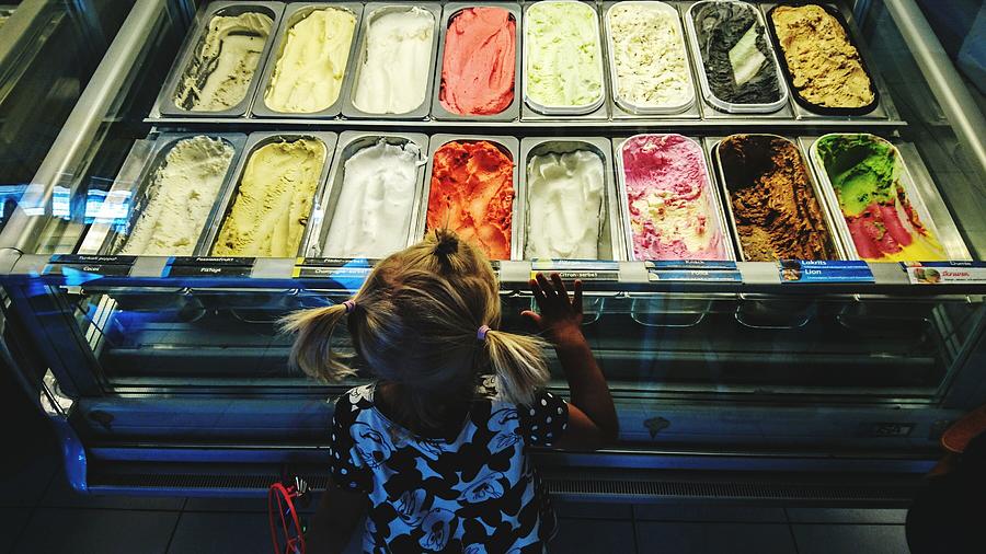 High Angle View Of Girl Looking At Ice Creams On Display In Store Photograph by Mathias Darmell / EyeEm