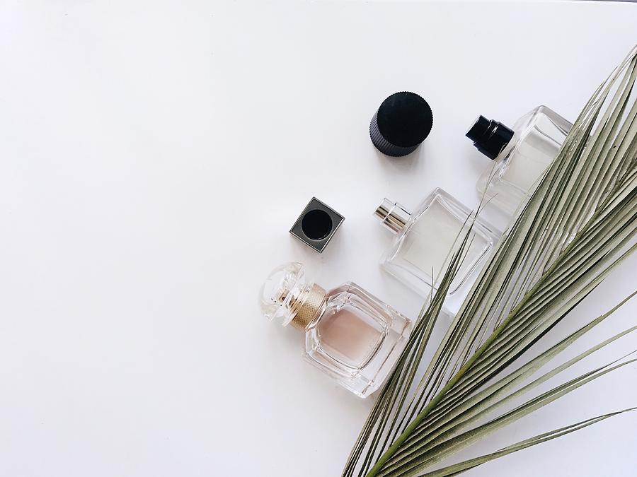 High Angle View Of Perfume And Leaf On Table Photograph by Olesia Valentain / EyeEm