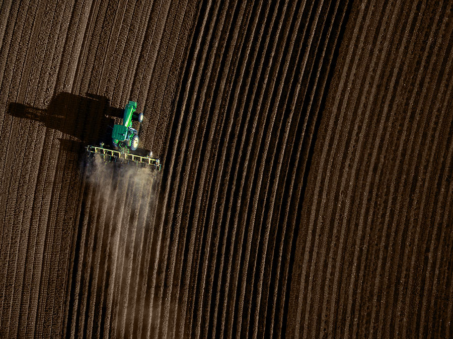 High angle view of tractor plowing a field Photograph by SDI Productions
