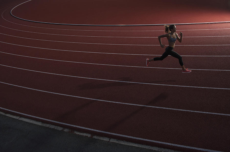 High angle view of young female athlete running on race track Photograph by Brian Caissie