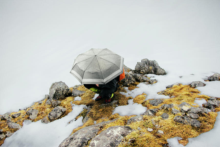 Nature Photograph - Hiker Crouching Under Umbrella by Marko Radovanovic