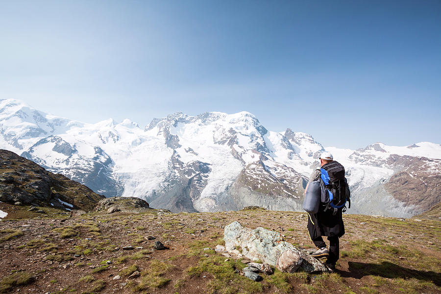Hiker Looking At Monte Rosa Glacier In Photograph by Matteo Colombo