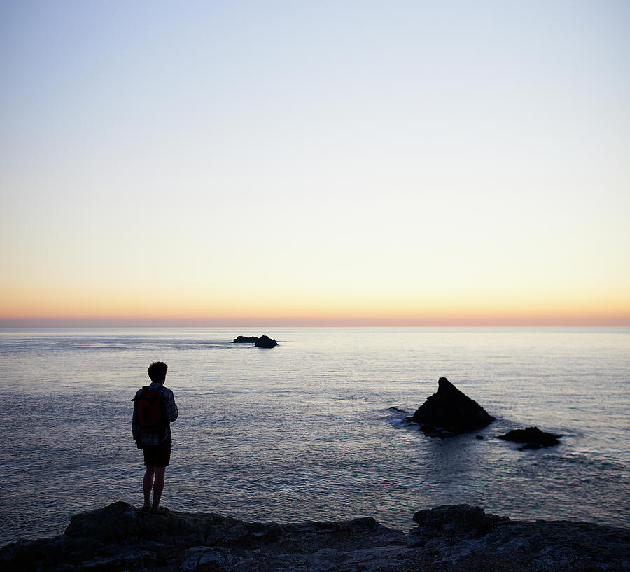 Hiker Looking Out To Sea Photograph by Dougal Waters Hiker Looking Out To Sea Photograph by Dougal Waters
