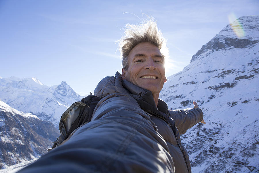 Hiker takes selfie portrait, in snowy mountains Photograph by Ascent/PKS Media Inc.