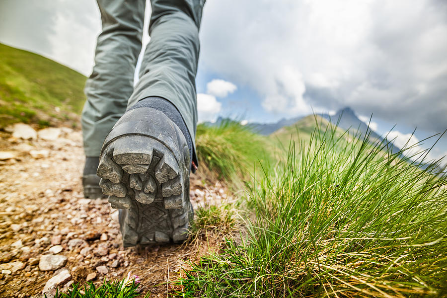 Hiker walks on Mountain Trail Photograph by Deimagine